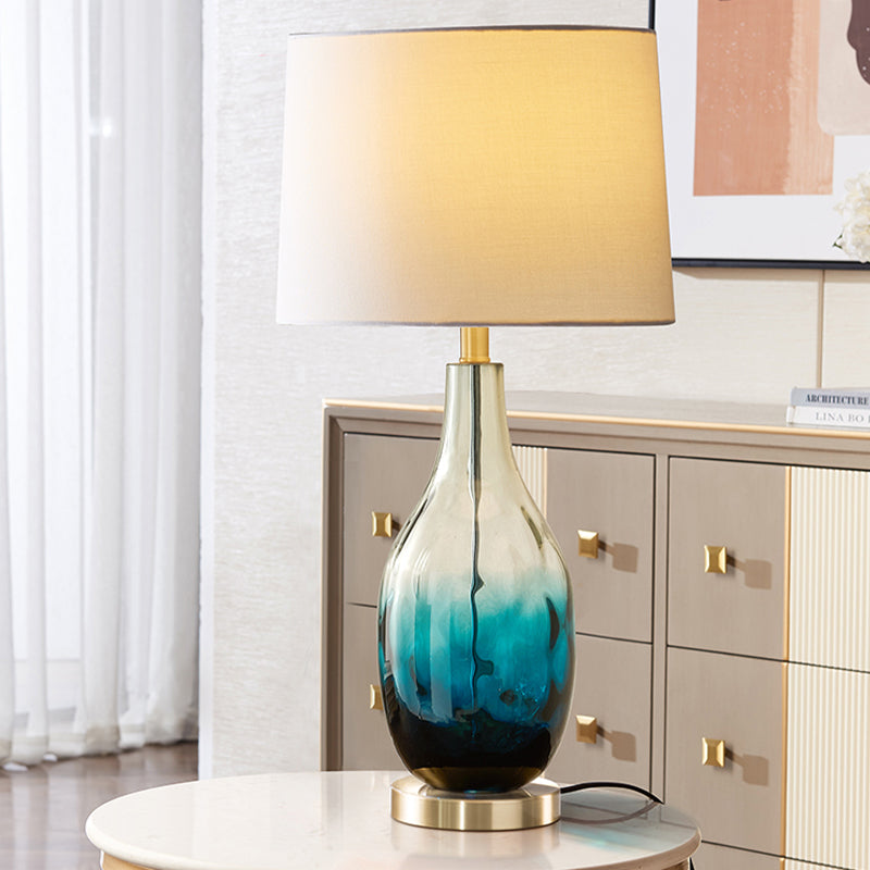 Beige/Brown 1 Head Nightstand Lamp Contemporary Fabric Drum Table Lighting with Jar Fading Blue Glass Base Clearhalo 'Lamps' 'Table Lamps' Lighting' 1136553