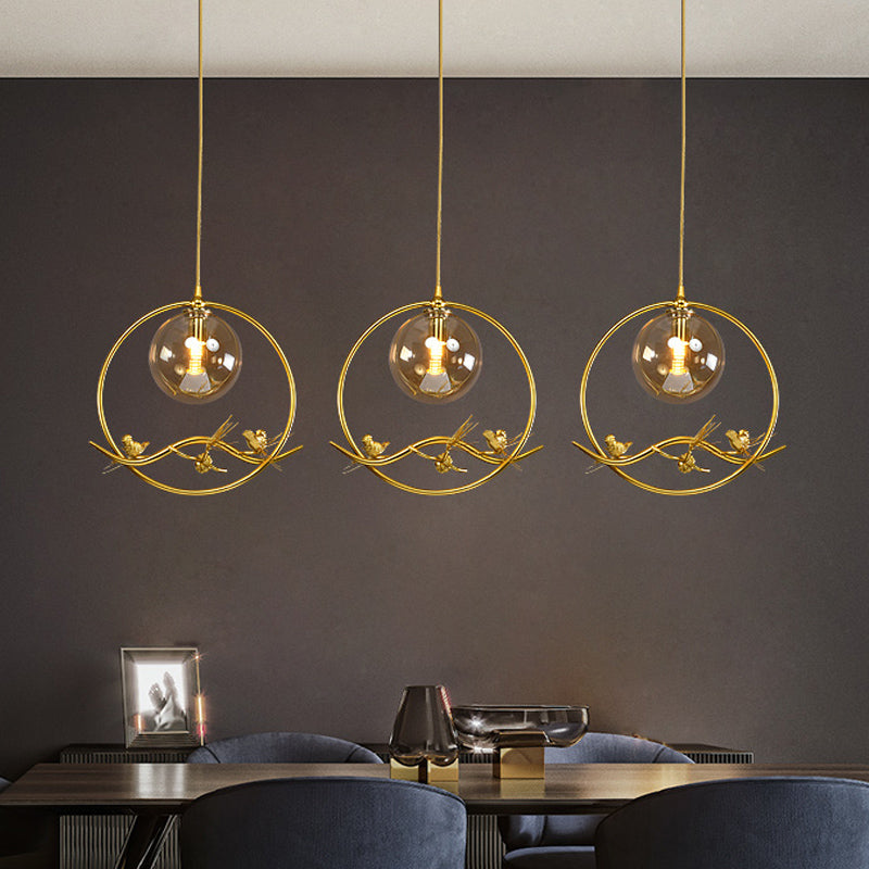 Brass Ring Hanging Pendant Mid-Century Single Bulb Metal Ceiling Lamp with Amber/Smoke Grey Glass Shade and Bird Deco Clearhalo 'Ceiling Lights' 'Glass shade' 'Glass' 'Modern Pendants' 'Modern' 'Pendant Lights' 'Pendants' Lighting' 1455012