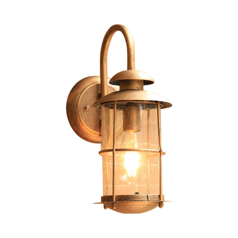 1 Light Wall Lamp Lighting Coastal Cylinder Clear Glass Sconce Light Fixture in Brass with Cage Clearhalo 'Art deco wall lights' 'Cast Iron' 'Glass' 'Industrial wall lights' 'Industrial' 'Middle century wall lights' 'Modern' 'Rustic wall lights' 'Tiffany' 'Traditional wall lights' 'Wall Lamps & Sconces' 'Wall Lights' Lighting' 192382