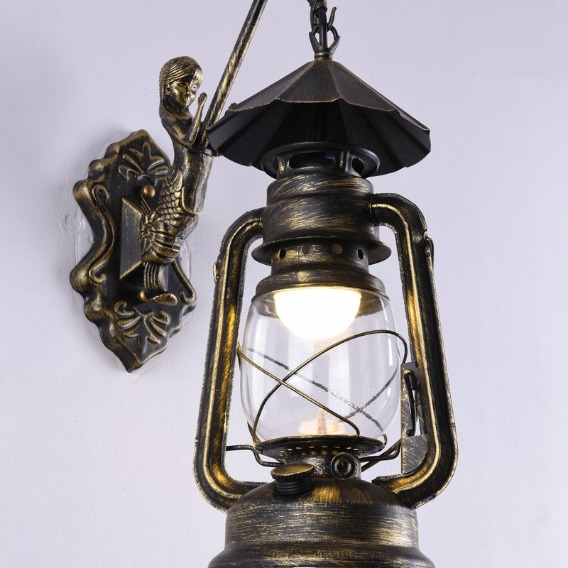 Clear Glass Kerosene Wall Light Fixture Nautical 1 Head Restaurant Wall Sconce with Curved Arm Brass B Clearhalo 'Art deco wall lights' 'Cast Iron' 'Glass' 'Industrial wall lights' 'Industrial' 'Middle century wall lights' 'Modern' 'Rustic wall lights' 'Tiffany' 'Traditional wall lights' 'Wall Lamps & Sconces' 'Wall Lights' Lighting' 2011505