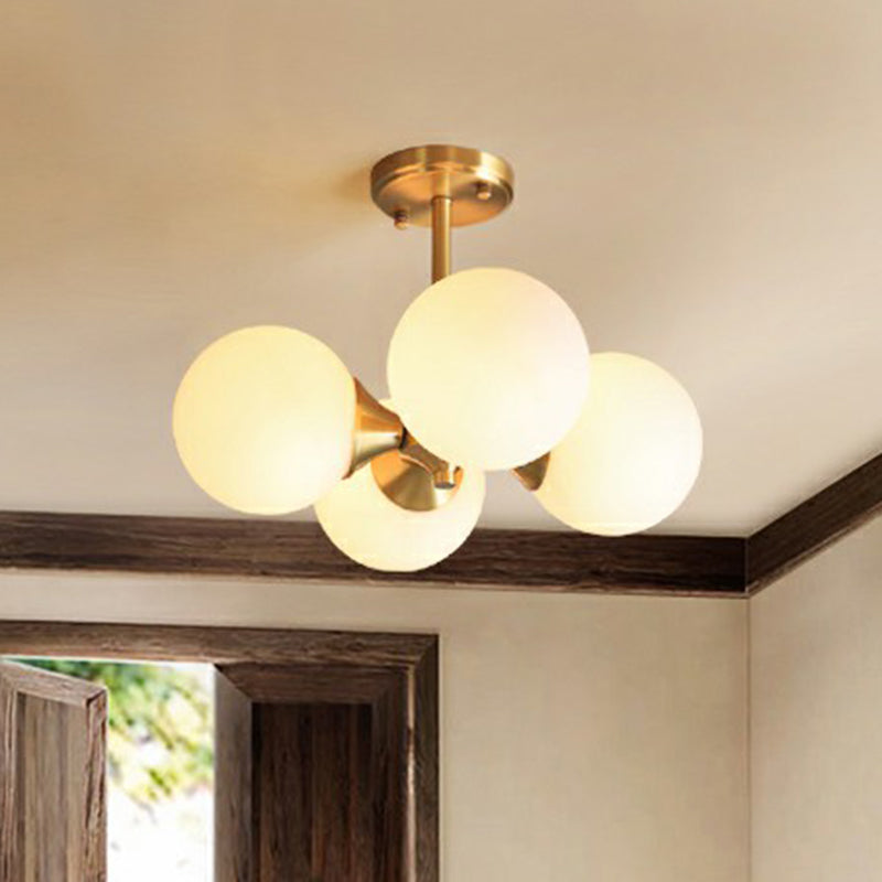 Brass Globe Flush Mount Lighting Postmodern 4 Heads Opal Glass Semi Flush Light for Bedroom Clearhalo 'Ceiling Lights' 'Chandeliers' 'Modern Chandeliers' 'Modern' Lighting' 2354234