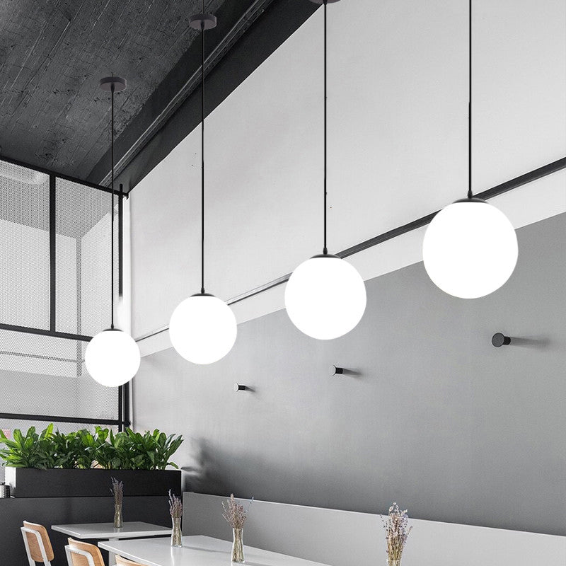 Sphere Restaurant Pendant Light Cream Glass 1 Head Simple Ceiling Hang Lamp in Black Clearhalo 'Ceiling Lights' 'Modern Pendants' 'Modern' 'Pendant Lights' 'Pendants' Lighting' 2356900