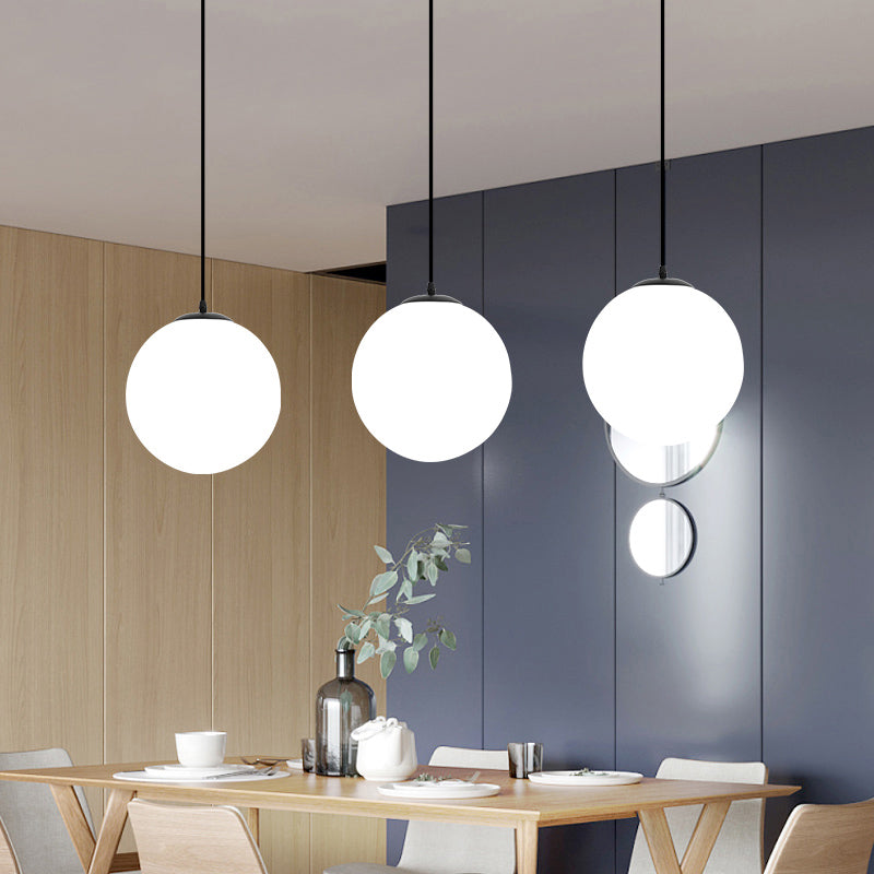 Sphere Restaurant Pendant Light Cream Glass 1 Head Simple Ceiling Hang Lamp in Black Clearhalo 'Ceiling Lights' 'Modern Pendants' 'Modern' 'Pendant Lights' 'Pendants' Lighting' 2356901