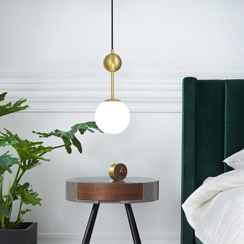 Ball Bedside Hanging Light Opaline Glass 1-Light Minimalist Suspension Pendant in Brass Clearhalo 'Ceiling Lights' 'Modern Pendants' 'Modern' 'Pendant Lights' 'Pendants' Lighting' 2356924