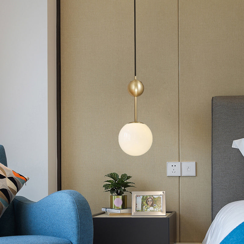 Ball Bedside Hanging Light Opaline Glass 1-Light Minimalist Suspension Pendant in Brass Clearhalo 'Ceiling Lights' 'Modern Pendants' 'Modern' 'Pendant Lights' 'Pendants' Lighting' 2356926