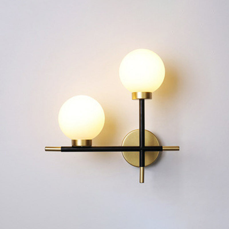 Mini Globe Milk Glass Wall Mount Light Modern 2-Light Black Sconce Fixture for Foyer Black Left Clearhalo 'Cast Iron' 'Glass' 'Industrial' 'Modern wall lights' 'Modern' 'Tiffany' 'Traditional wall lights' 'Wall Lamps & Sconces' 'Wall Lights' Lighting' 2423038