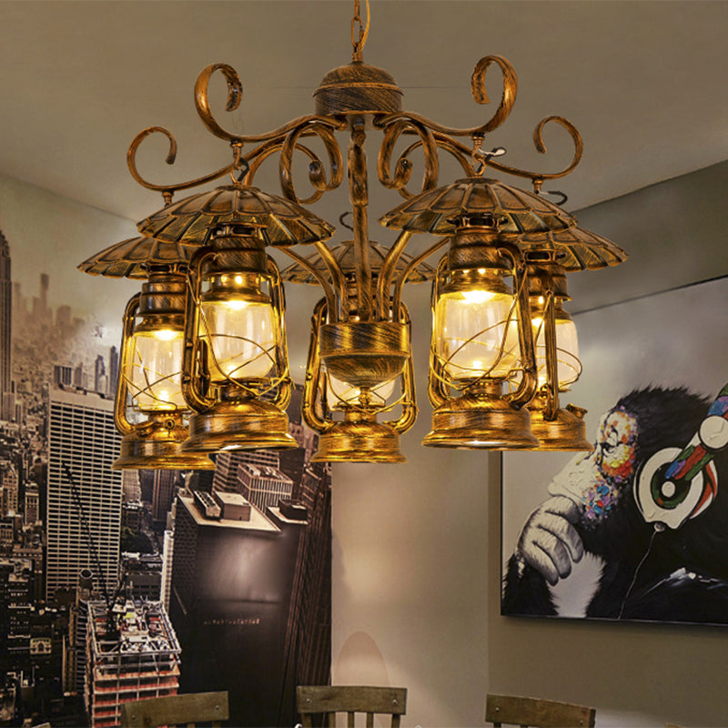 Aged Brass Lantern Suspension Light Village Style Metal and Clear Glass 5 Light Dining Room Chandelier Brass Clearhalo 'Ceiling Lights' 'Chandeliers' 'Close To Ceiling Lights' 'Glass shade' 'Glass' 'Industrial Chandeliers' 'Industrial' 'Middle Century Chandeliers' 'Tiffany' Lighting' 415926