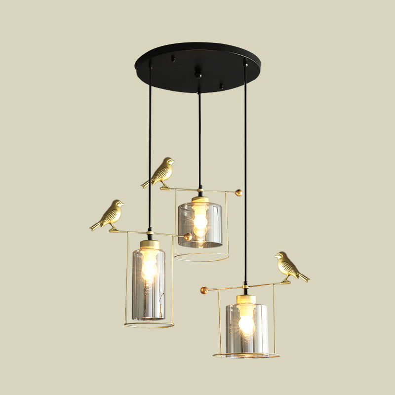 Cylinder Dining Room Cluster Pendant Cream/Smoke Gray Glass 3 Bulbs Modernism Suspension Lamp with Gold Bird Deco Clearhalo 'Ceiling Lights' 'Chandeliers' 'Glass shade' 'Glass' 'Modern Pendants' 'Modern' 'Pendant Lights' 'Pendants' Lighting' 731489