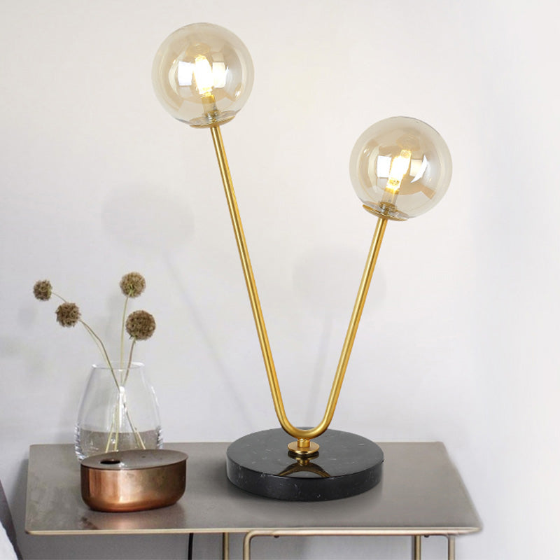 2 Bulbs Bedroom Table Light Post-Modern Black and Gold Night Lamp with Dual Ball Amber Glass Shade Clearhalo 'Lamps' 'Table Lamps' Lighting' 758998