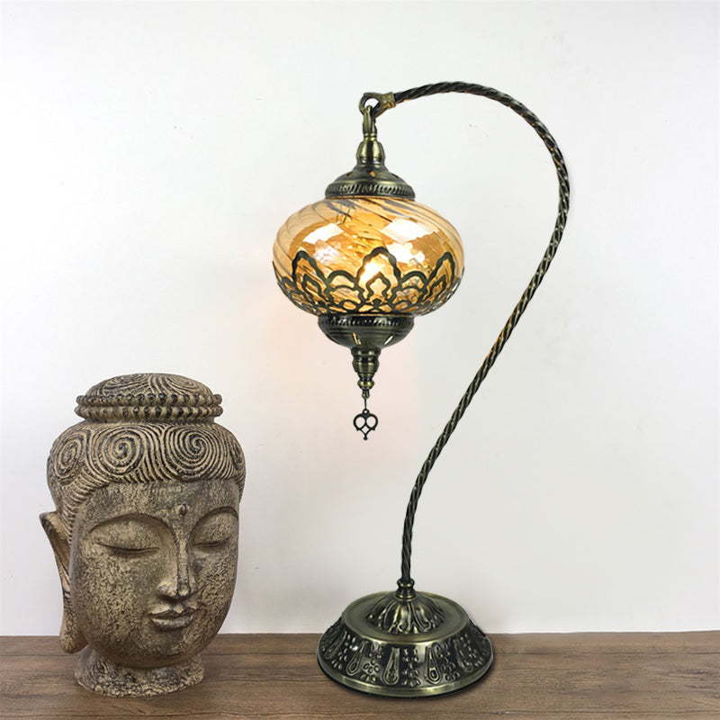 Brass/Gloss Black 1 Head Table Lamp Bohemia Amber Glass Oval/Urn Nightstand Lighting with Curved Arm Brass Clearhalo 'Lamps' 'Table Lamps' Lighting' 920936